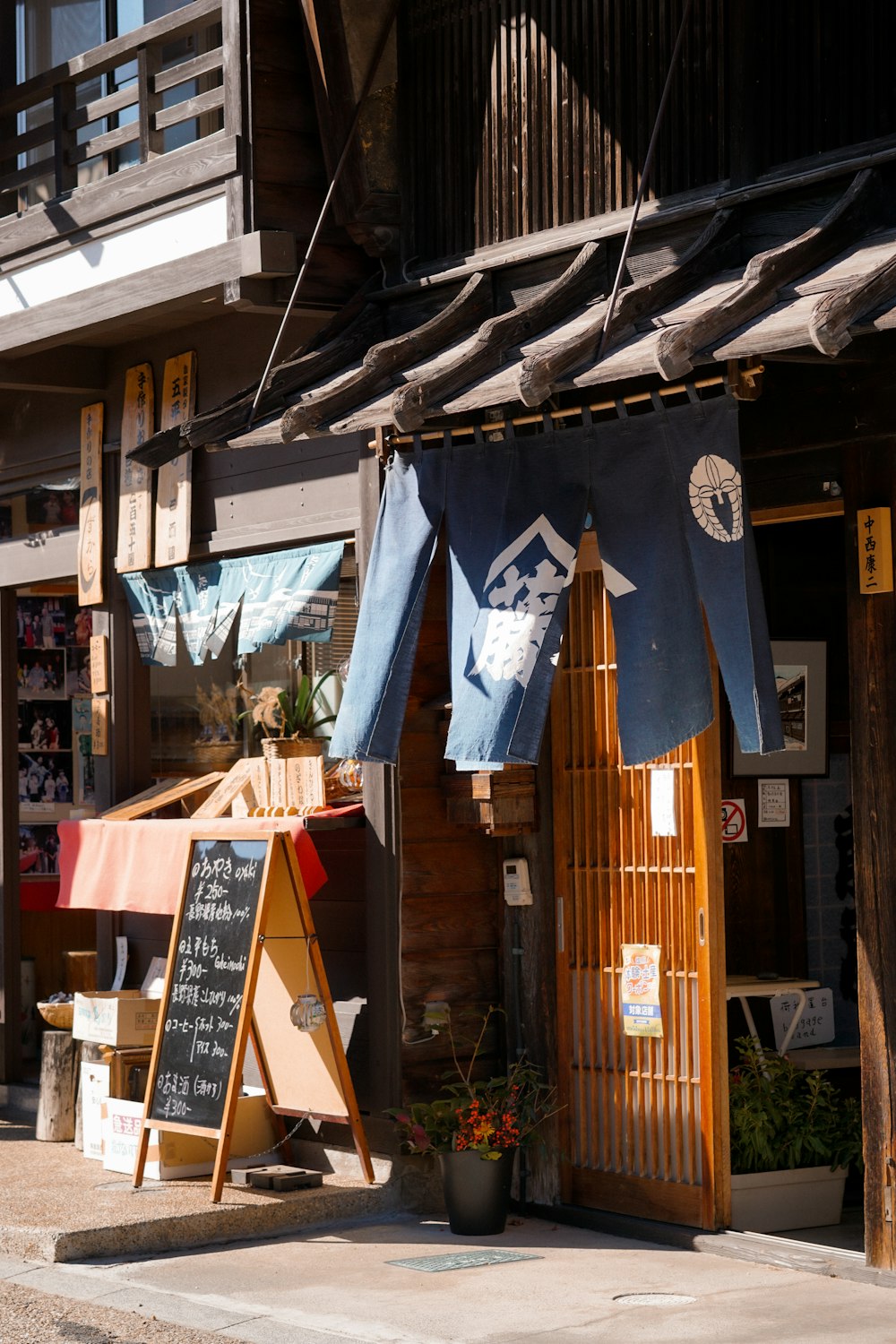 a store front with a sign and umbrellas outside of it