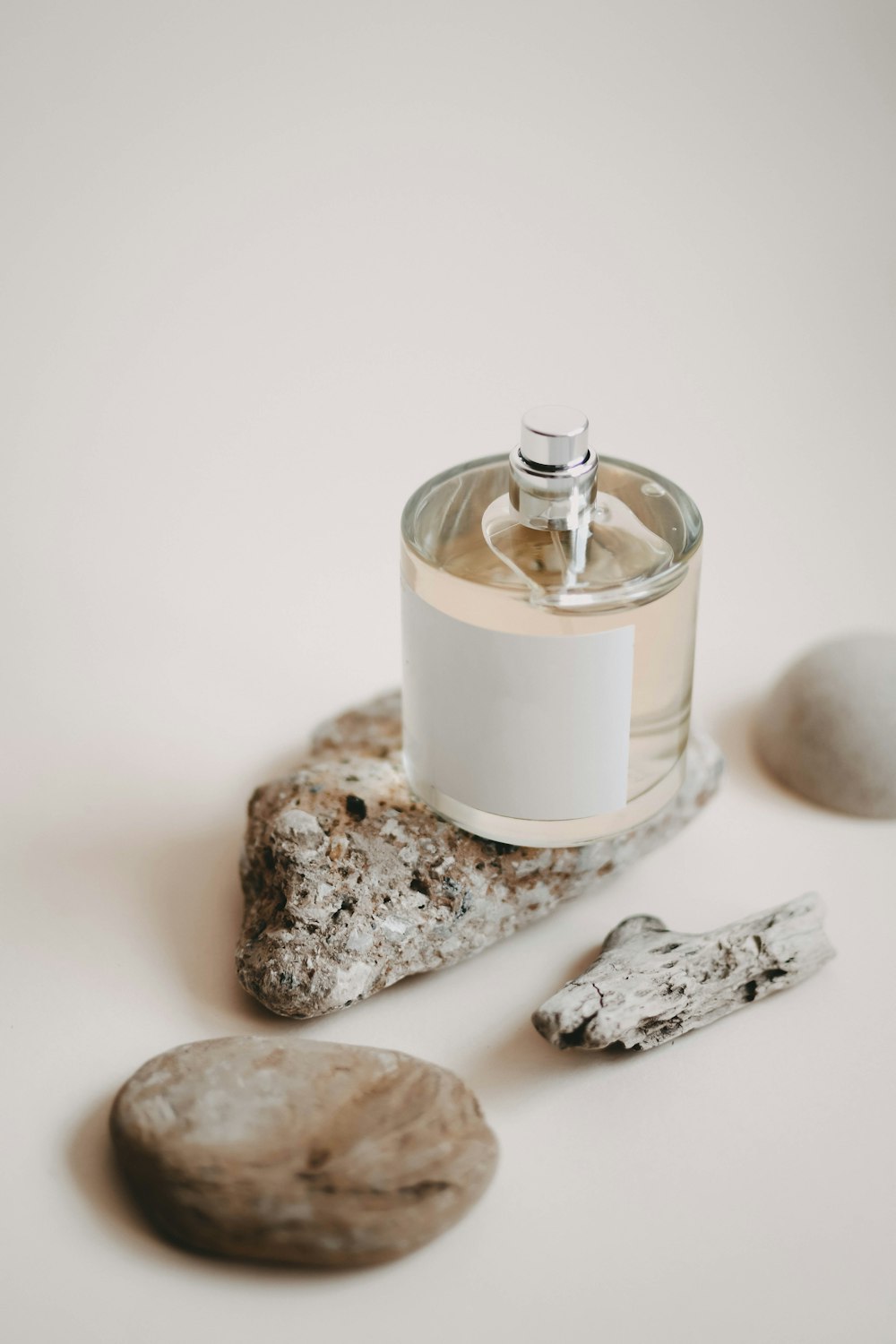 a jar of liquid sitting on top of a rock