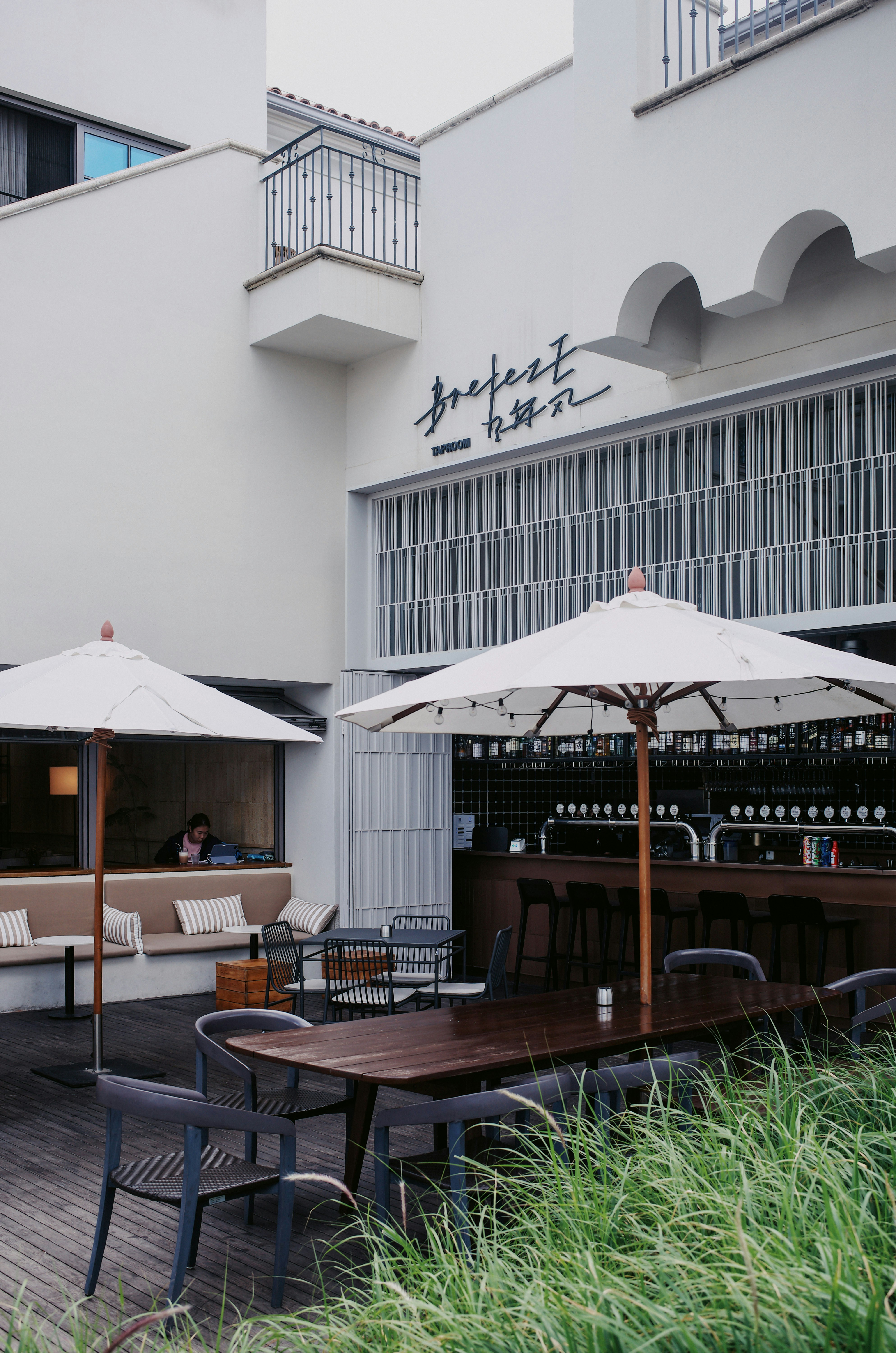 Tables and umbrellas arranged outside a restaurant.