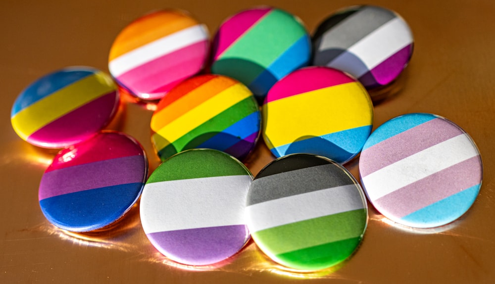 a bunch of colorful buttons sitting on top of a table