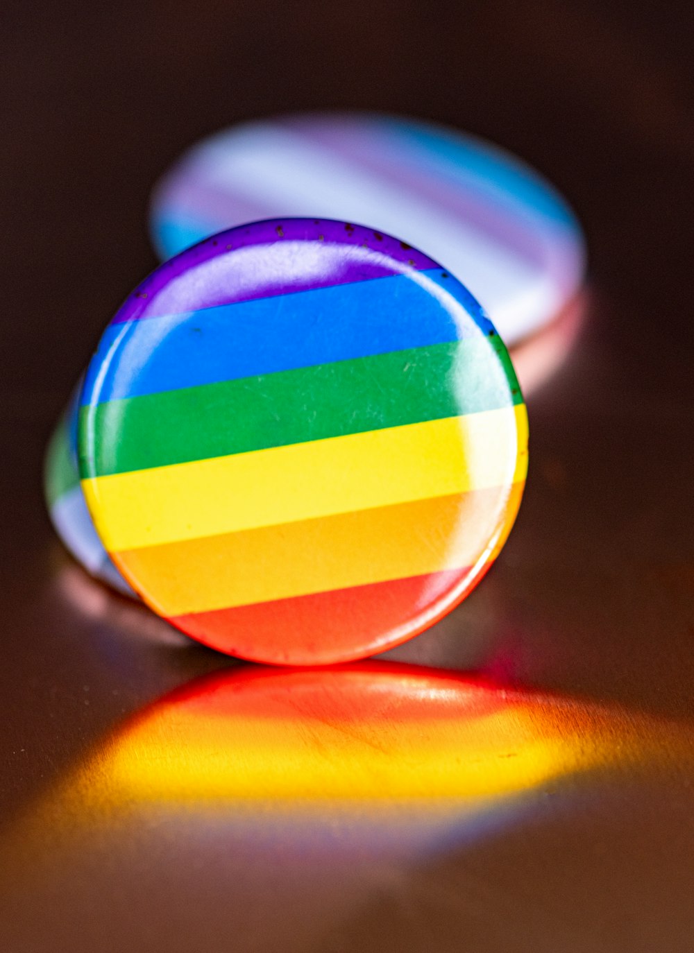 a rainbow colored button sitting on top of a table