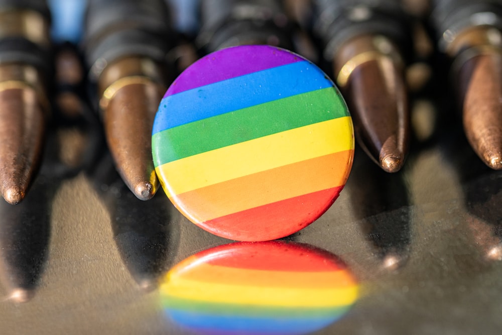 a rainbow colored button sitting on top of a table