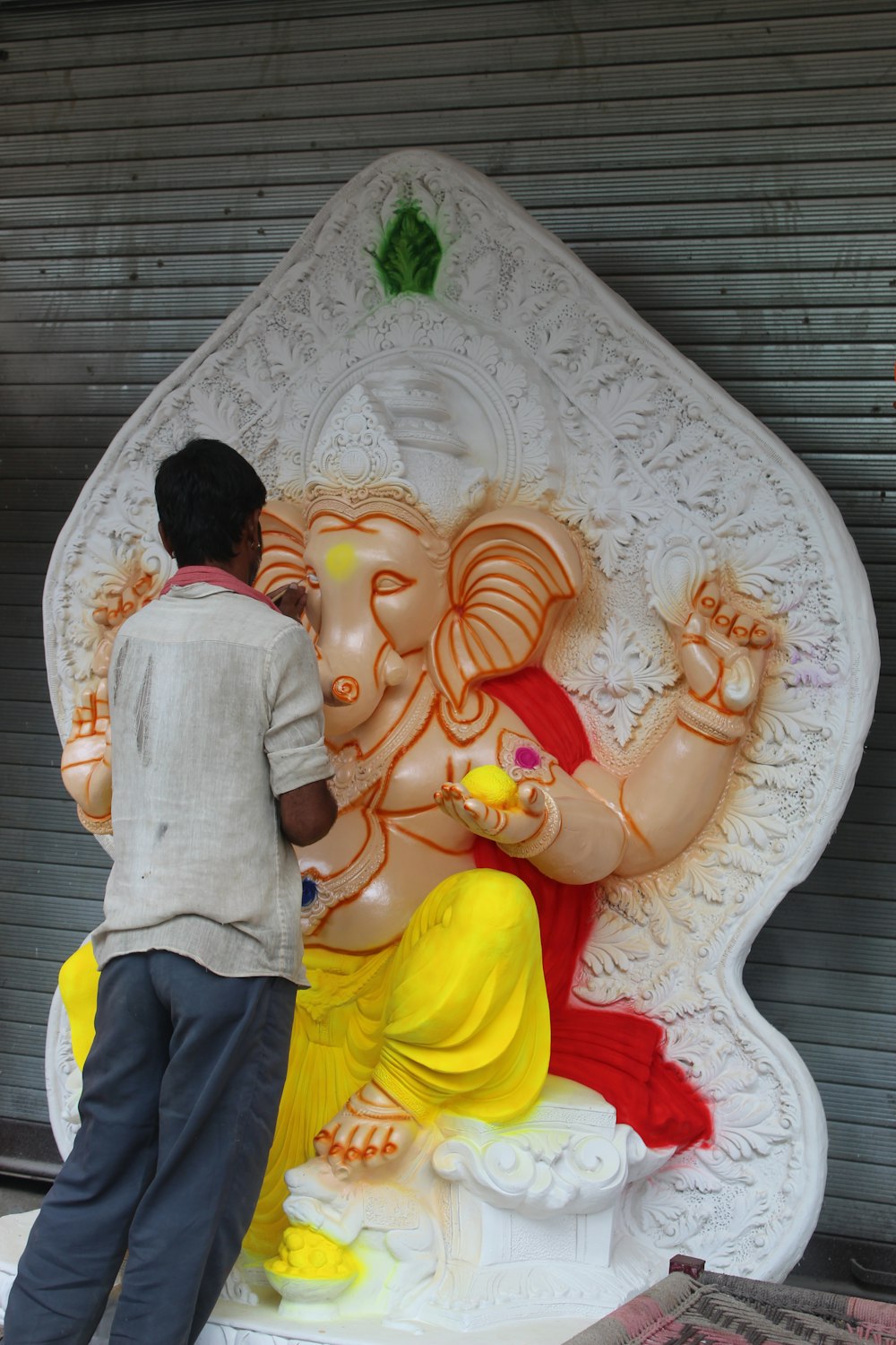 a man standing next to a statue of an elephant