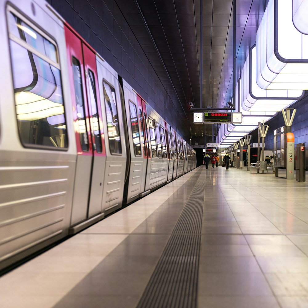 a subway train pulling into a train station