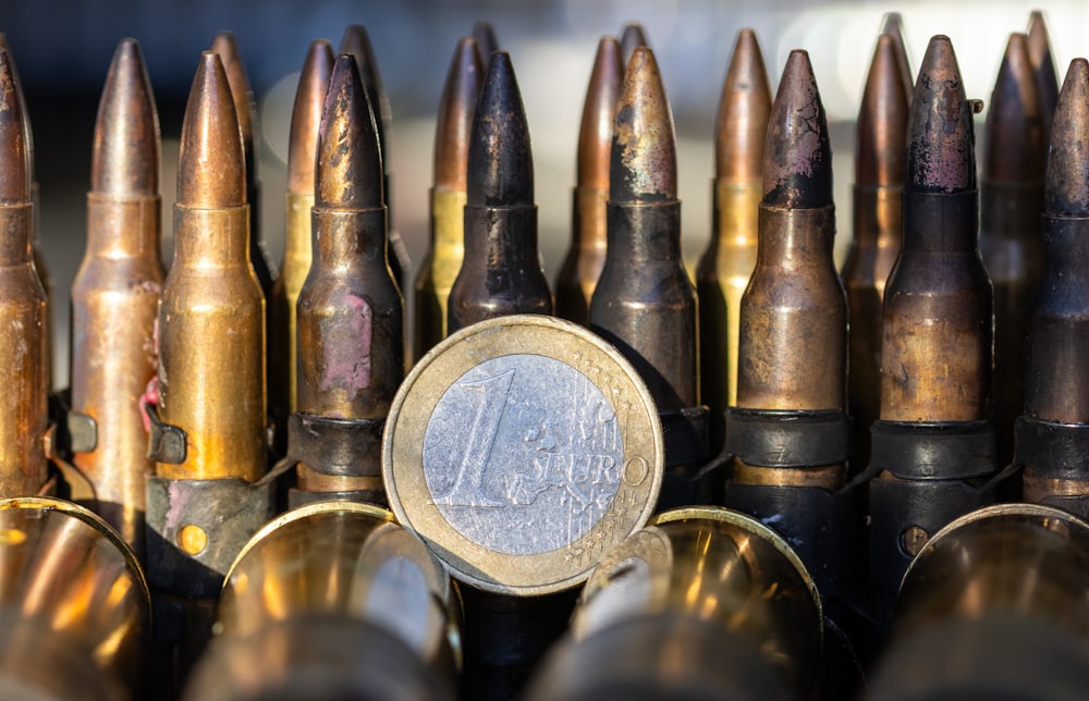 a pile of bullet casks with a penny in the middle