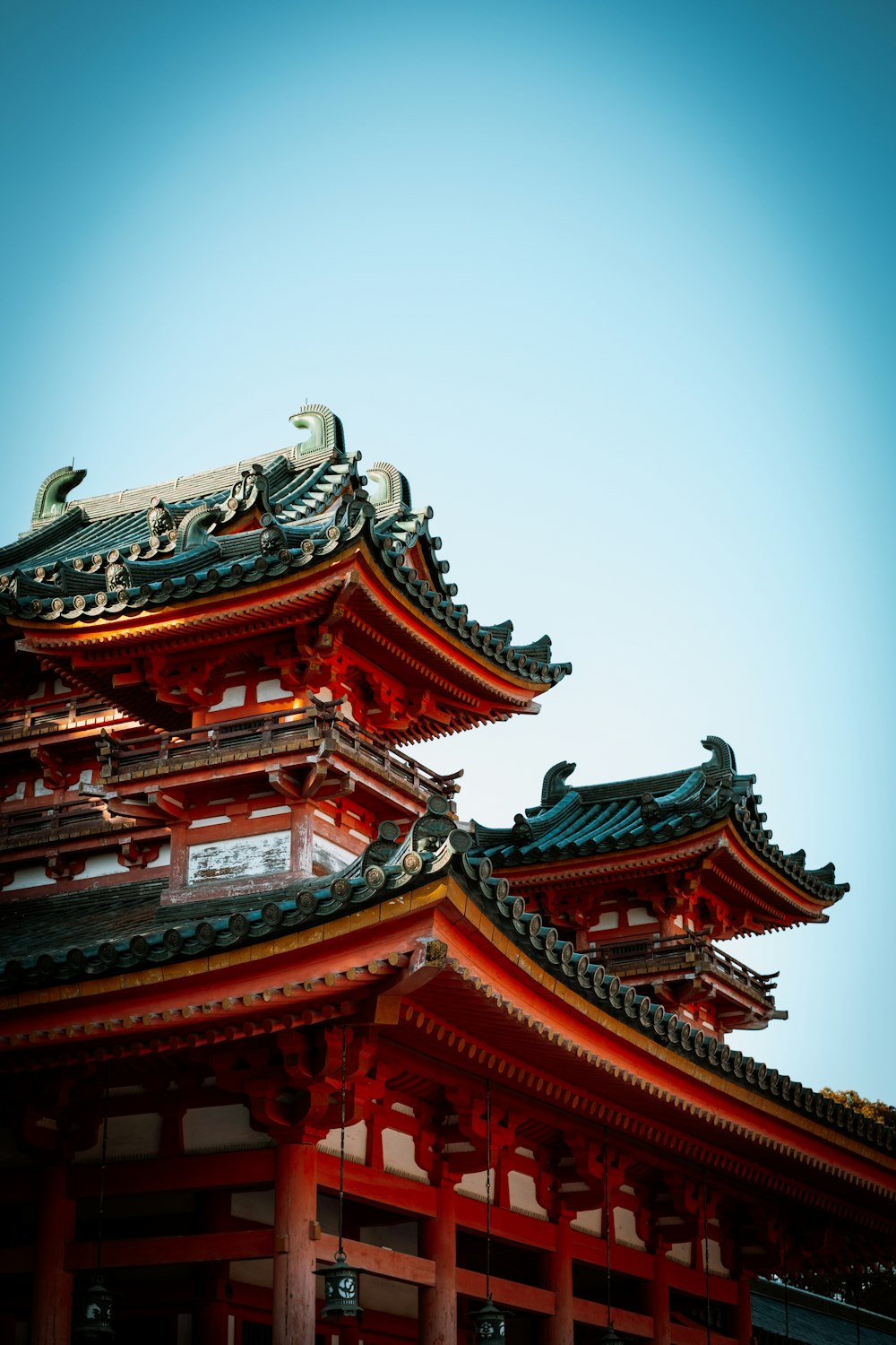 a tall red building with a sky in the background