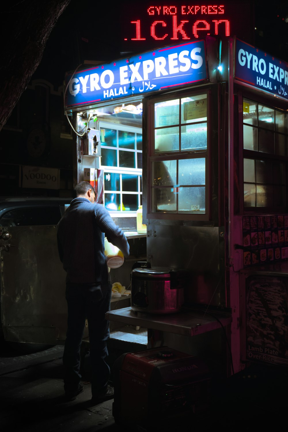 a man standing in front of a store at night