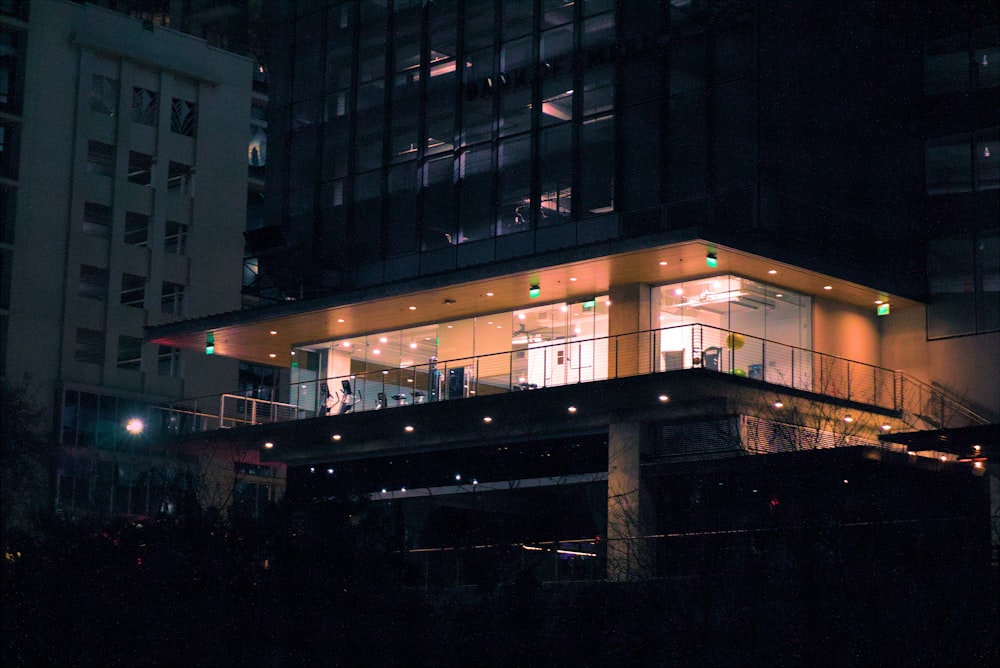 a building lit up at night with lights on