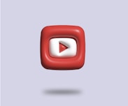 a red and white square with a video player on it
