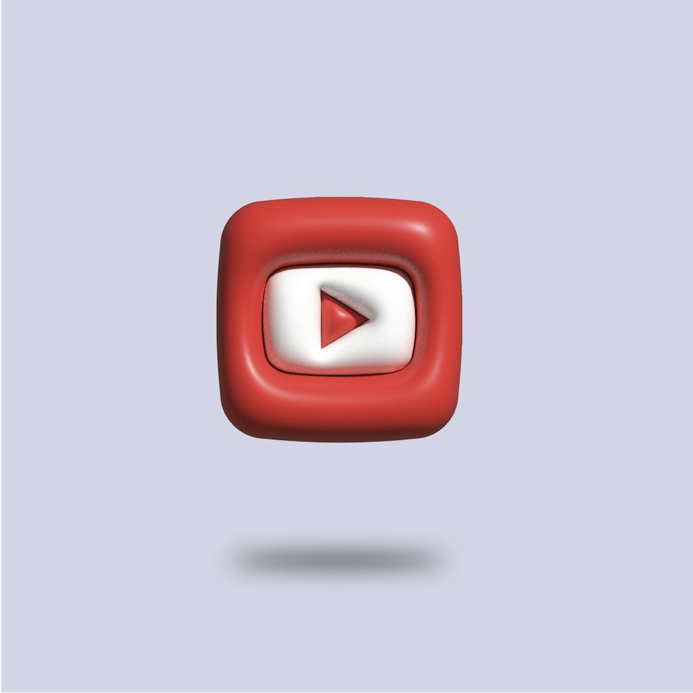 a red and white square with a video player on it