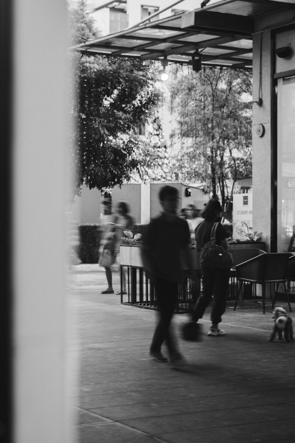 a group of people walking down a sidewalk