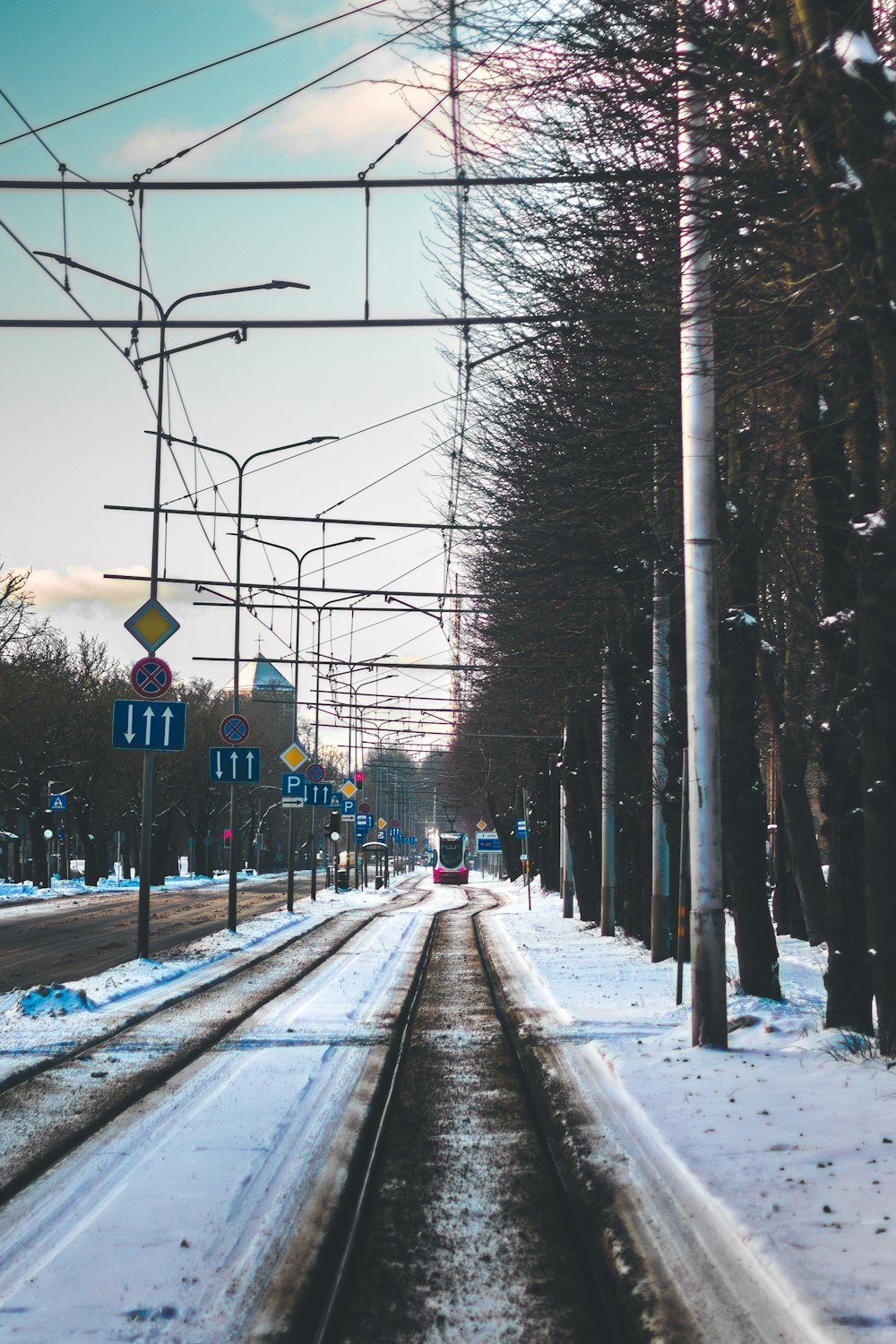 a train track in the middle of a snowy street