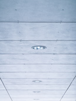 a long hallway with a ceiling made of wood planks