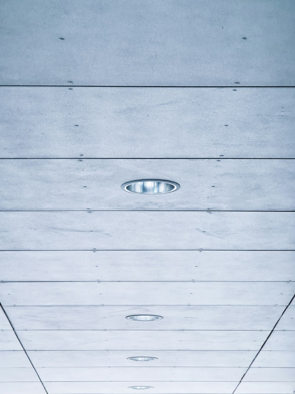 a long hallway with a ceiling made of wood planks