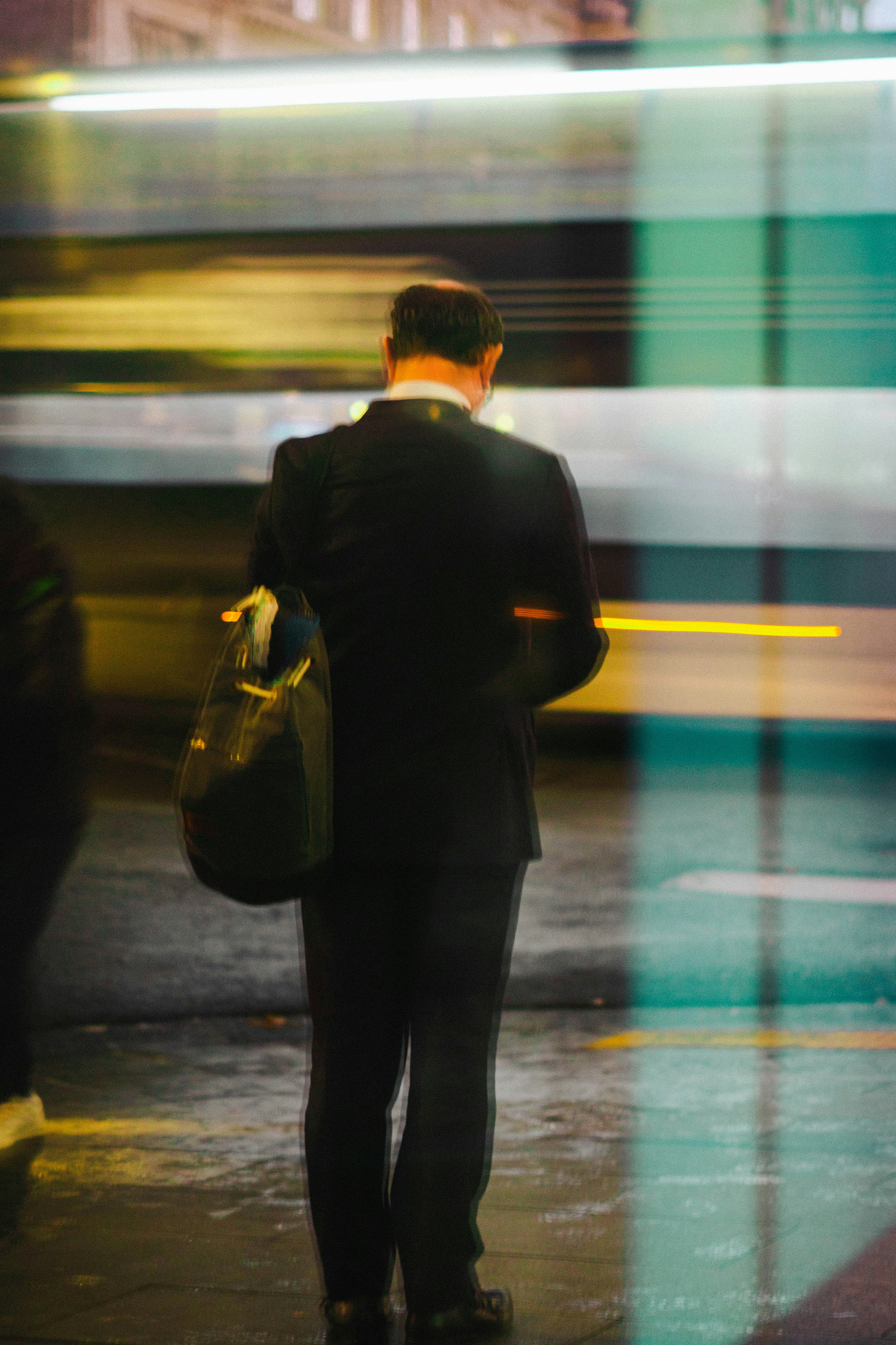 a man in a suit walking down a street