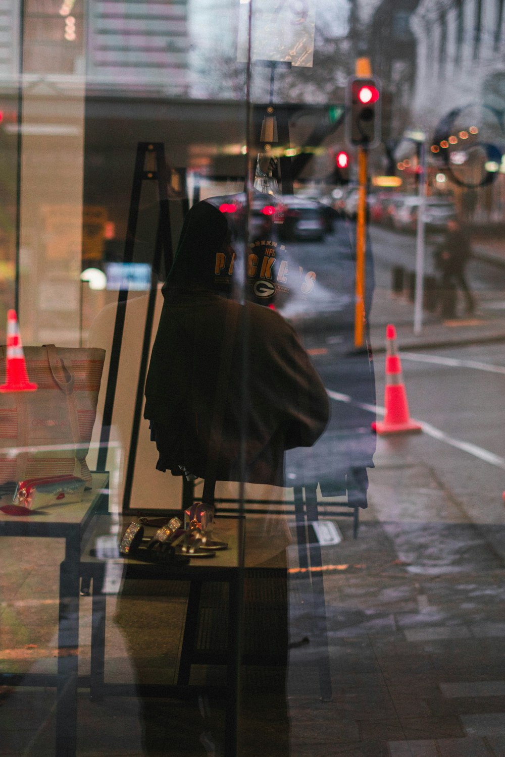 a person sitting at a table in front of a window