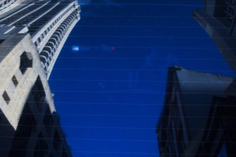 a reflection of a building in a car window