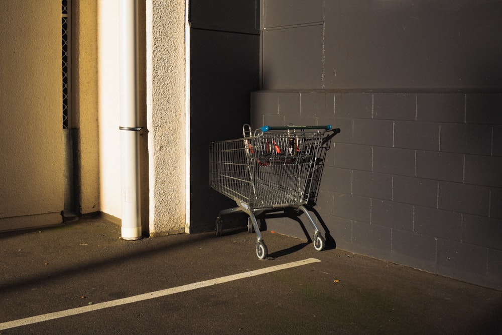 a shopping cart sitting in a parking lot next to a building