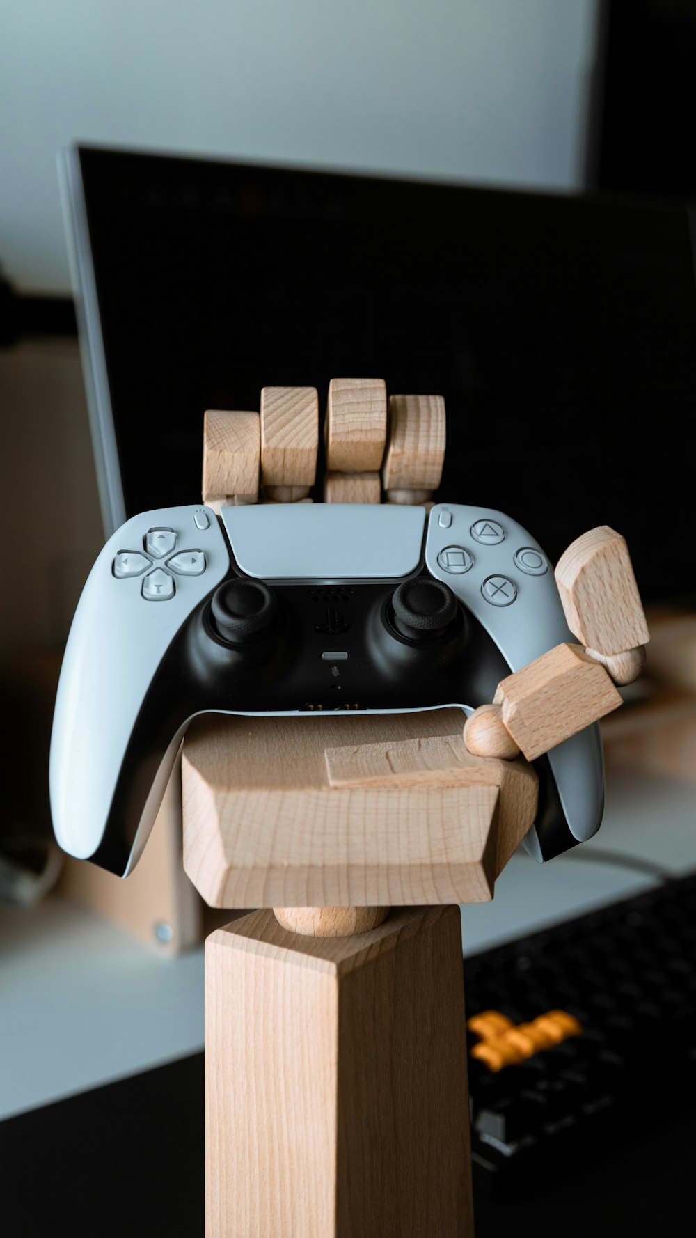 a video game controller on top of a wooden block