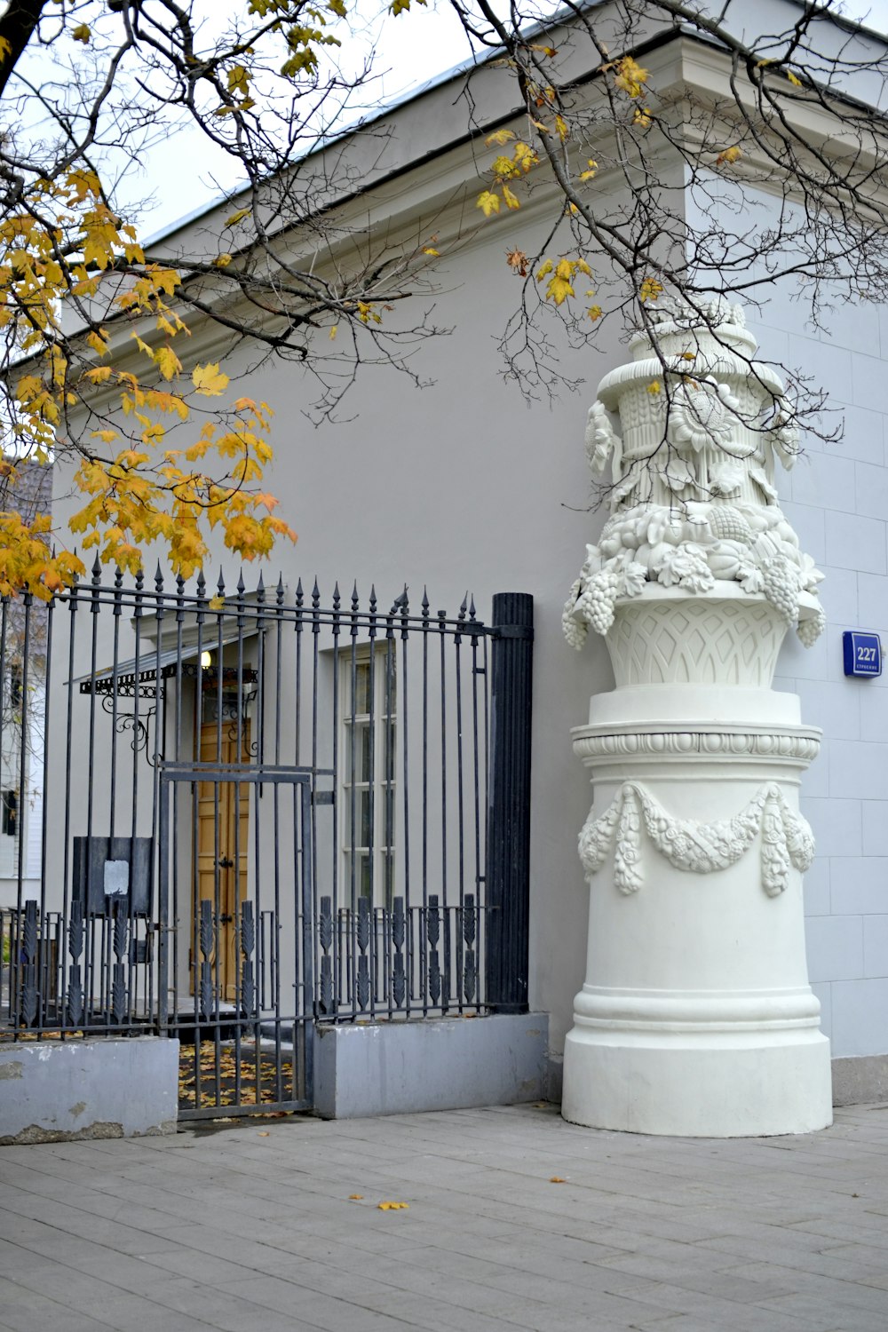 a tall white pillar sitting in front of a white building