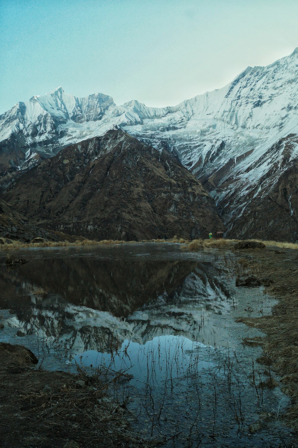 a mountain range with a lake in the foreground