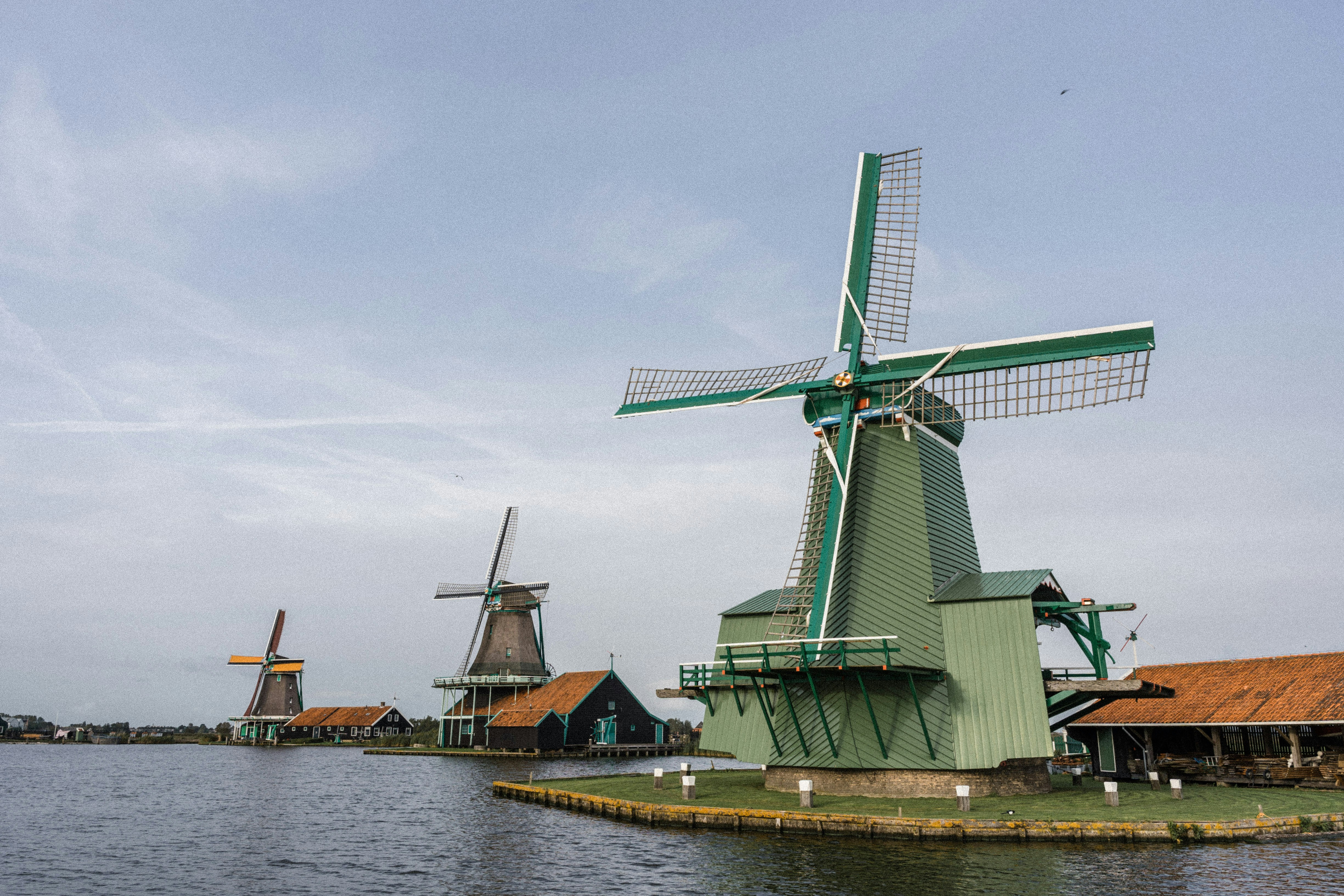 a group of windmills sitting next to a body of water