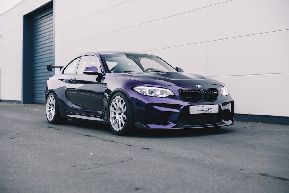 a purple car parked in front of a building