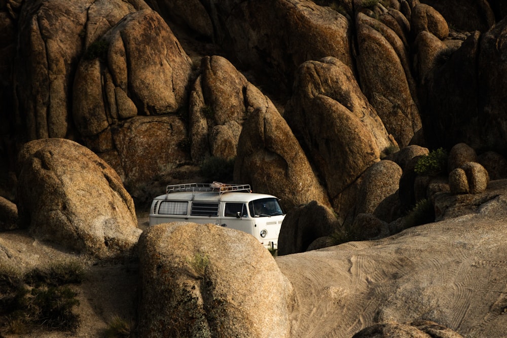 a van is parked in the middle of a rocky area