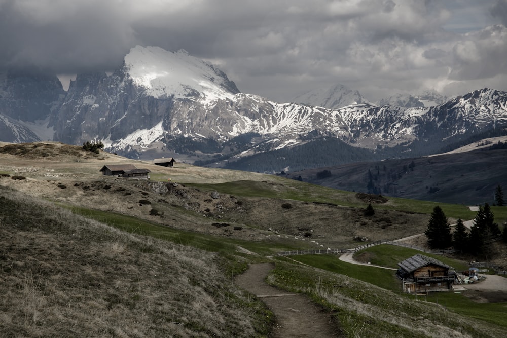 a house on a hill with mountains in the background