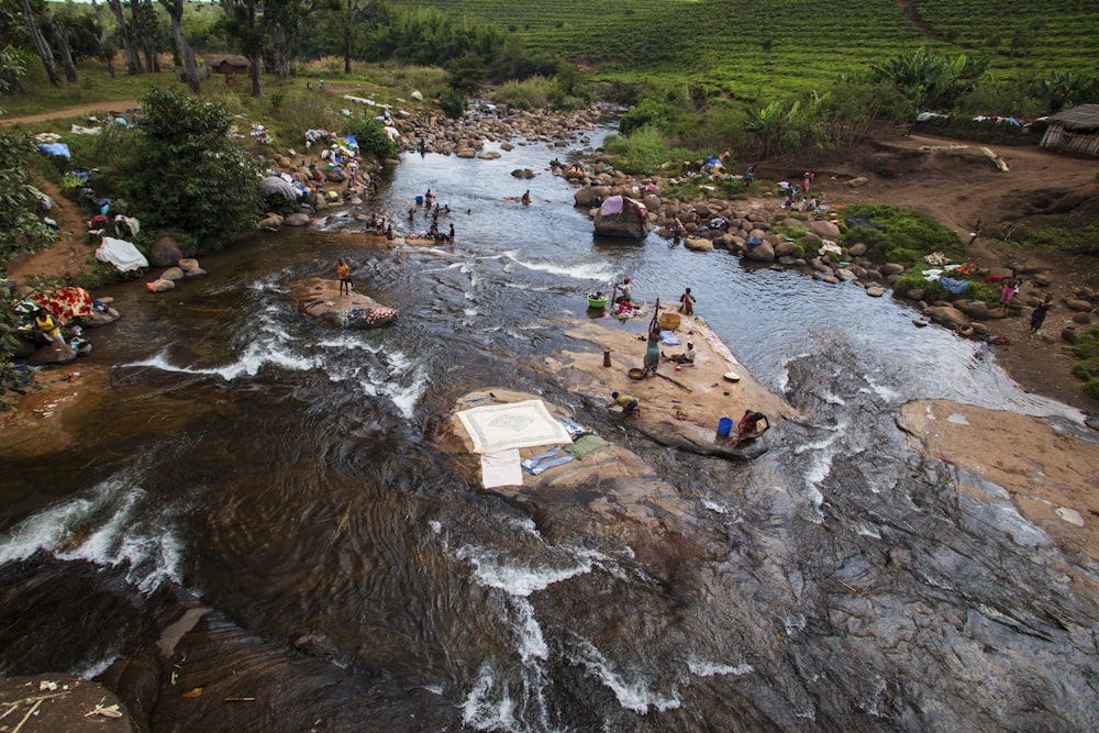 a group of people standing on top of a river