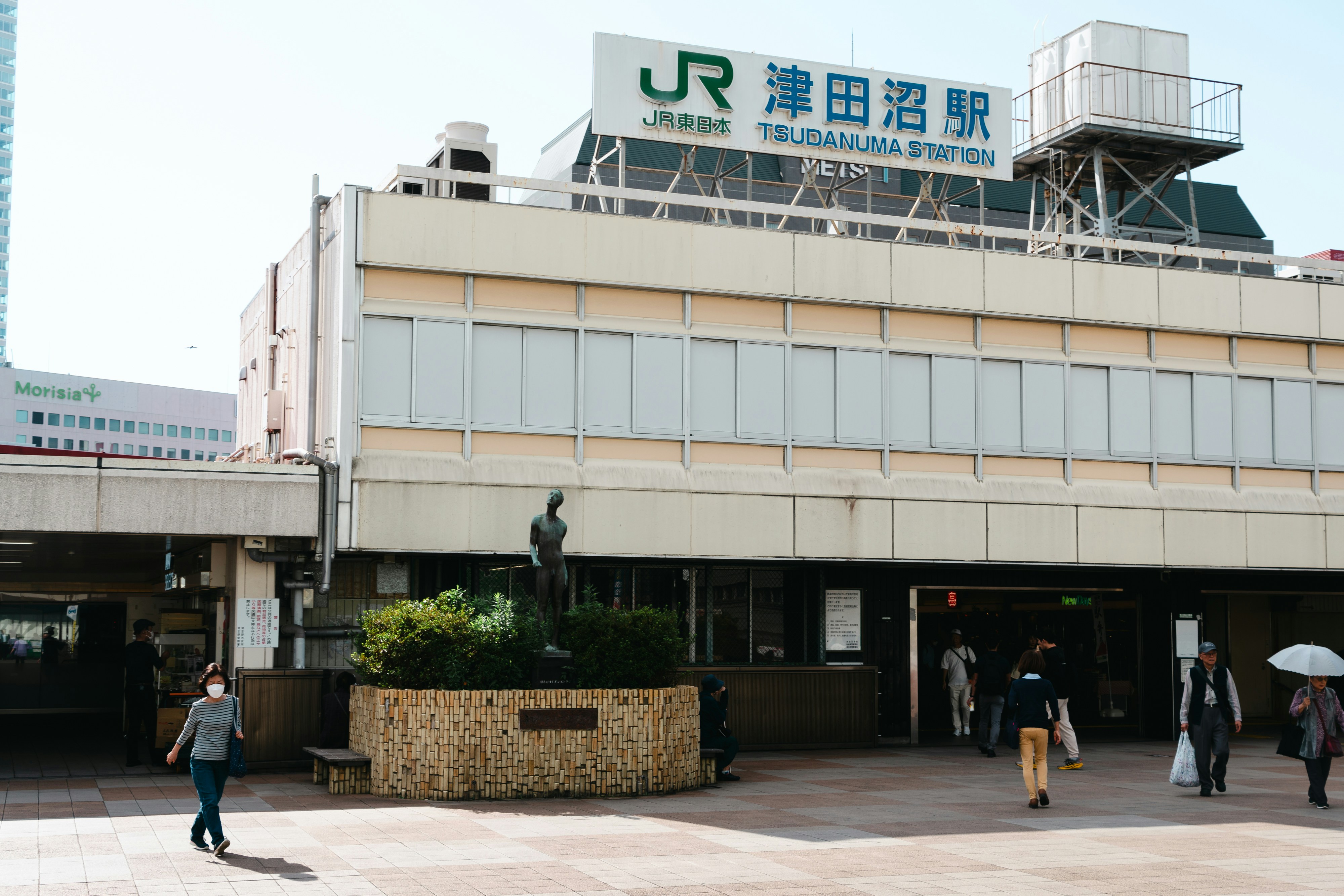 a group of people walking in front of a building