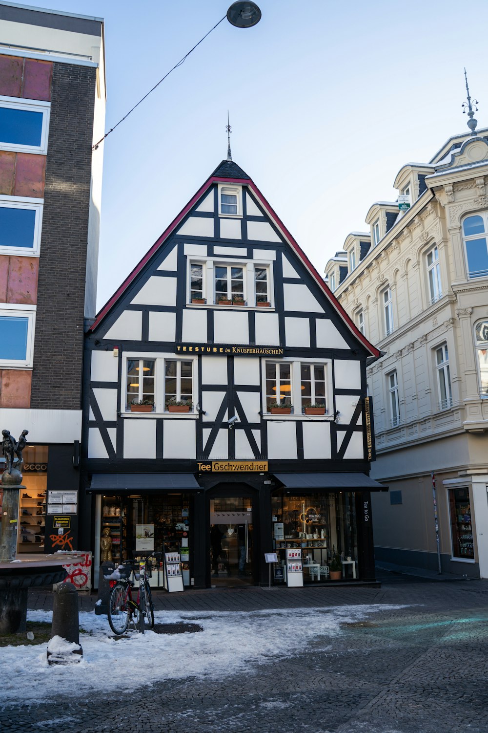 a black and white building with a bicycle parked in front of it