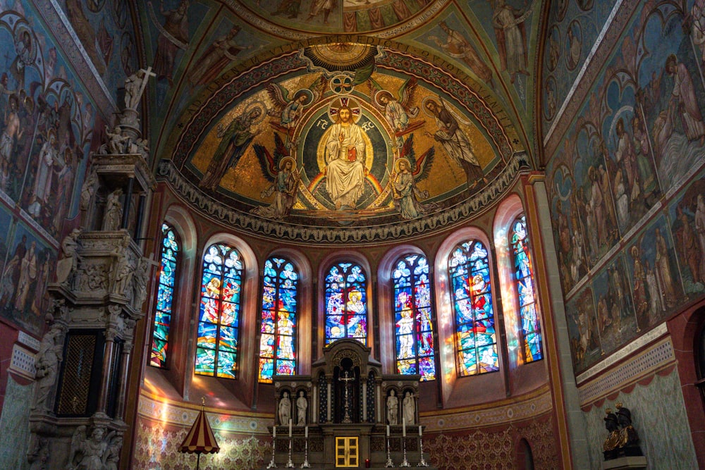 a church with stained glass windows and a statue