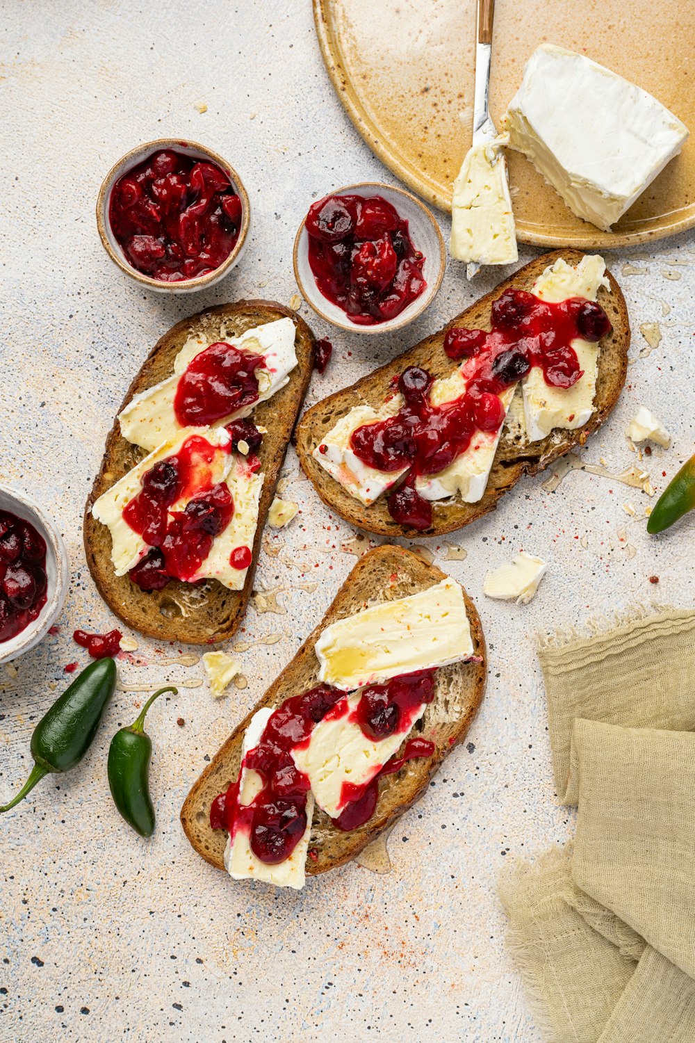 a table topped with slices of bread covered in cranberry sauce