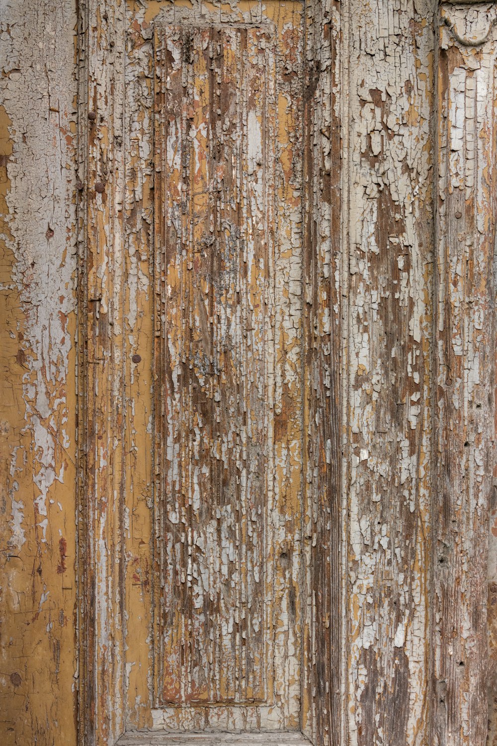 an old door with peeling paint on it