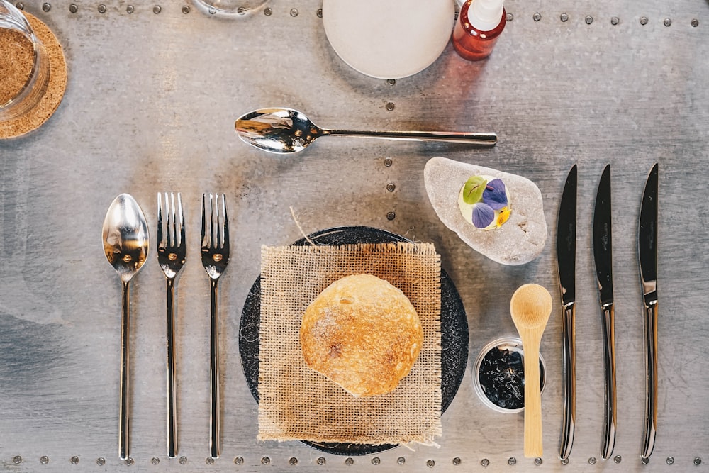 a table topped with a plate of food and silverware