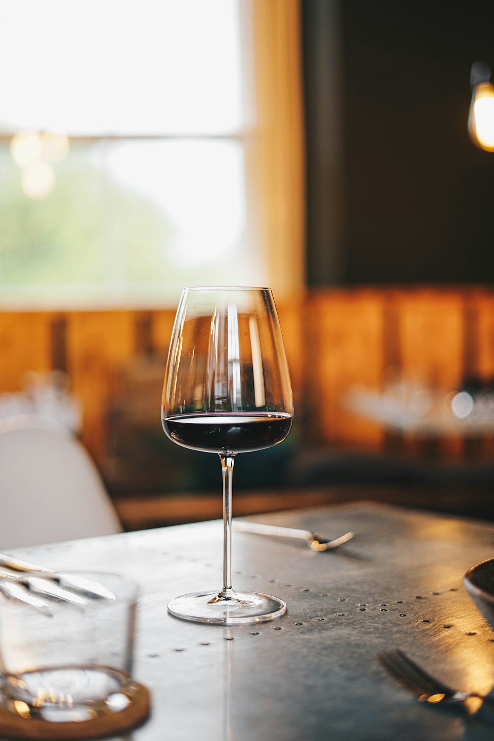 a glass of wine sitting on top of a table