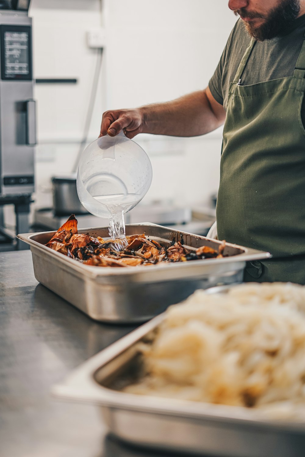 a man pours water into a container of food