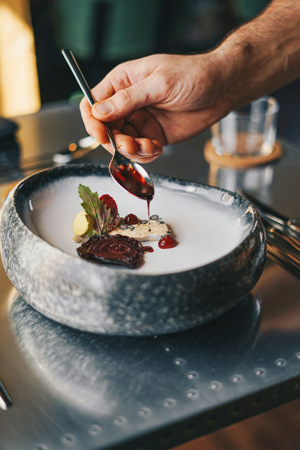 a person is spooning something into a plate