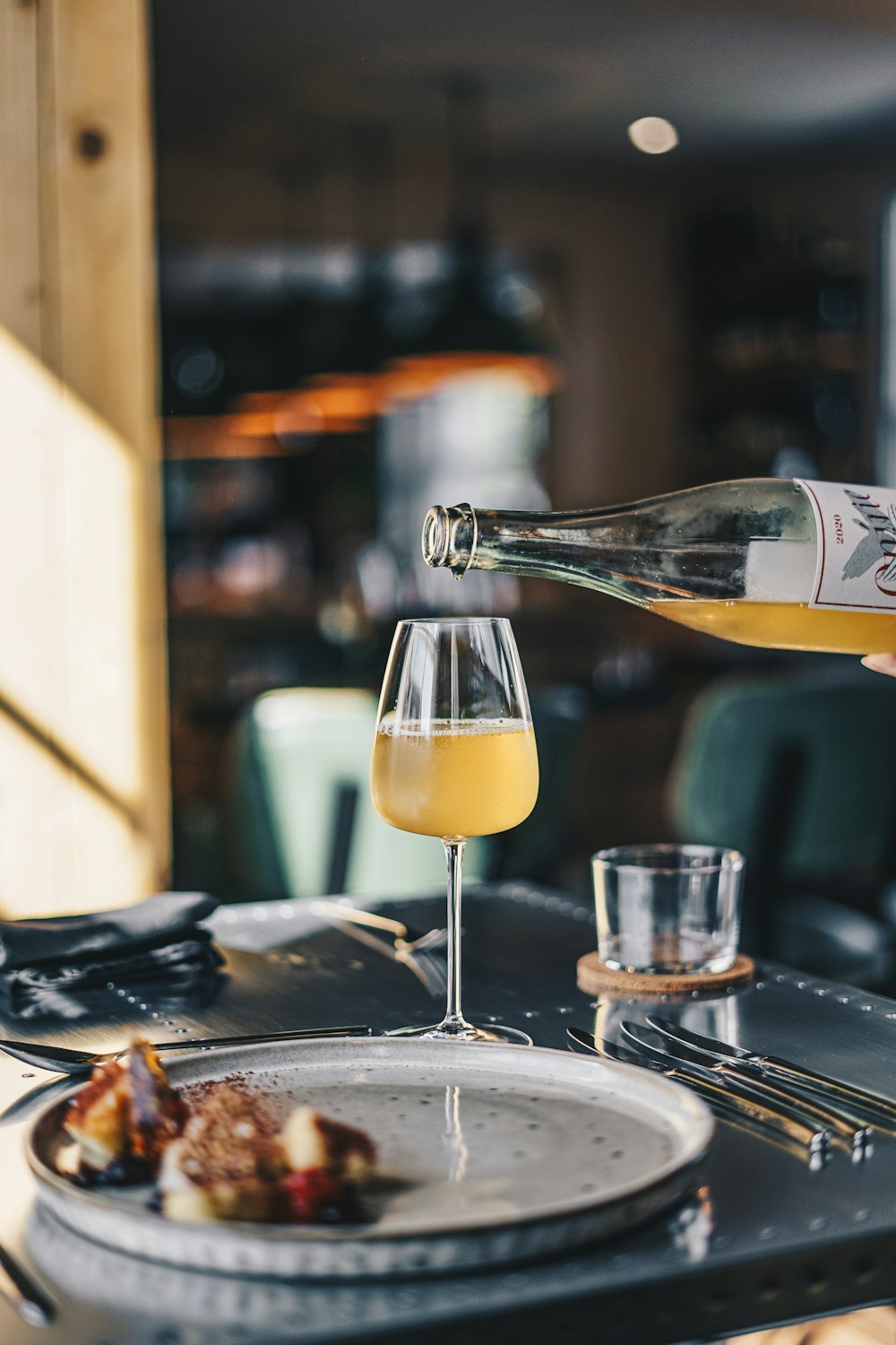 a plate of food and a bottle of wine on a table