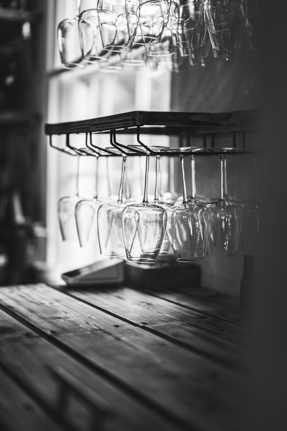 a shelf filled with wine glasses on top of a wooden table