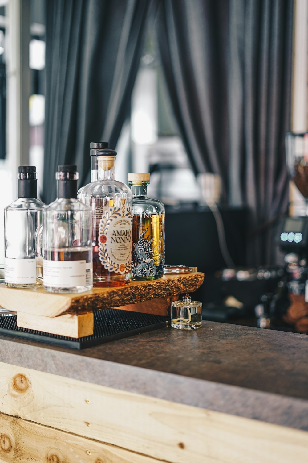 a wooden counter topped with bottles of liquor