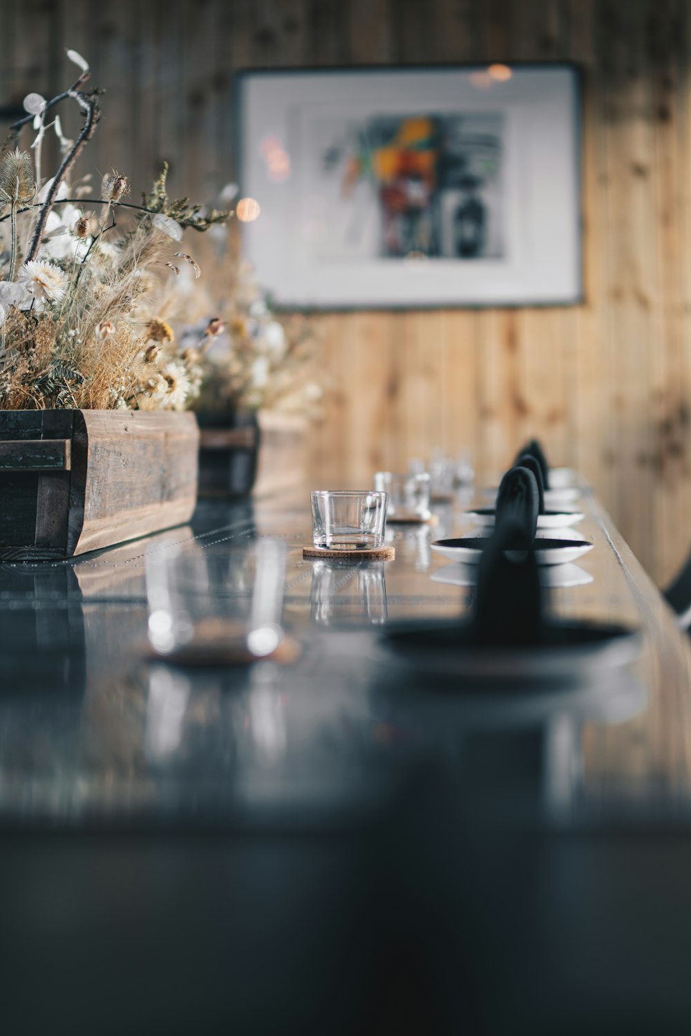 a long table with a vase of flowers on top of it