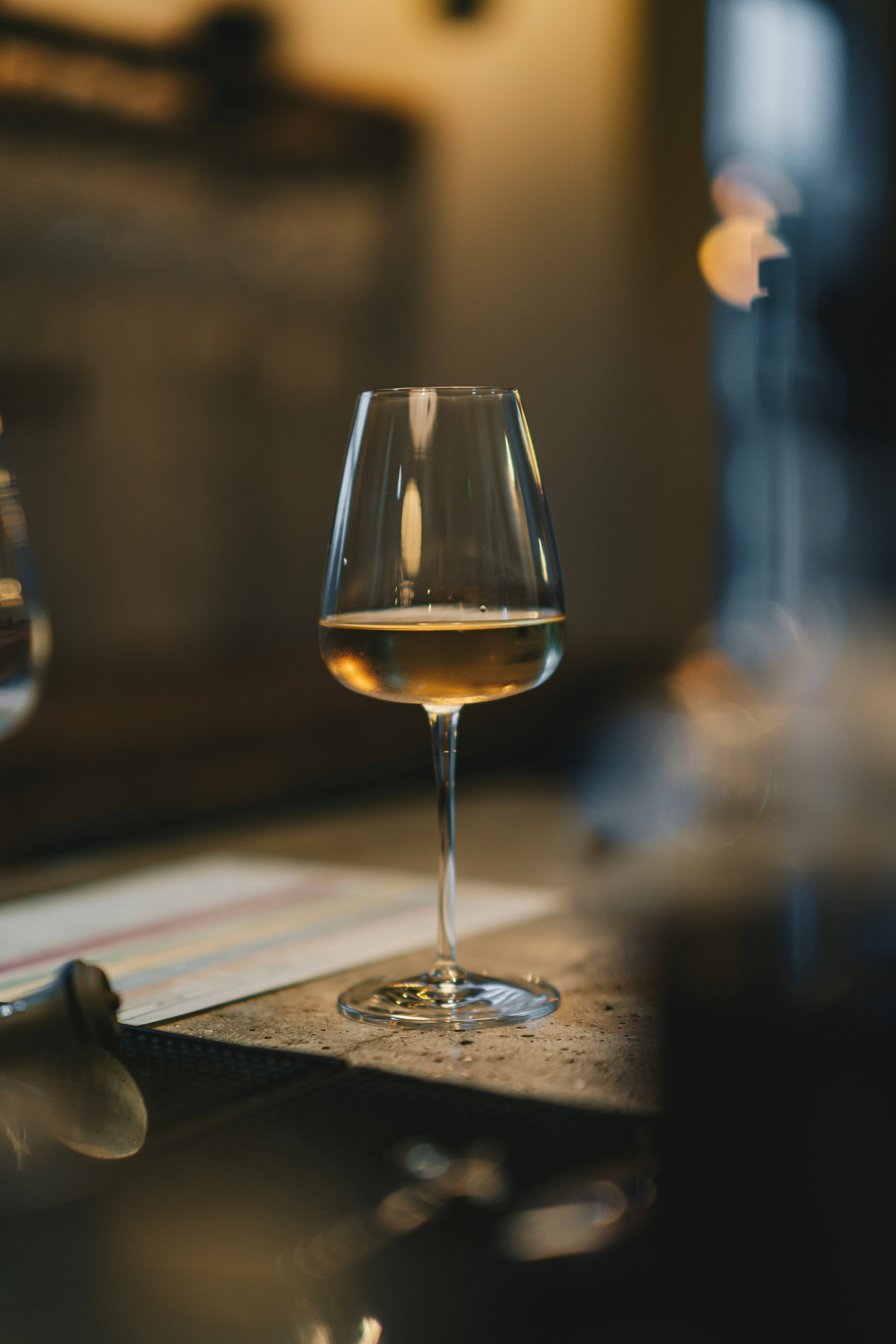 a glass of wine sitting on top of a table