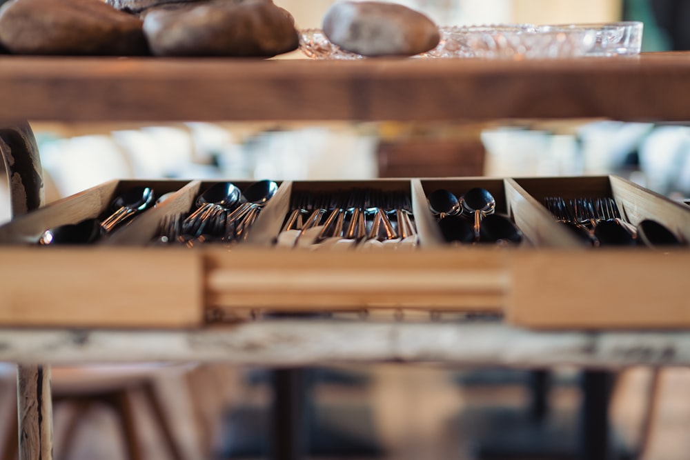 a wooden table topped with lots of wooden utensils