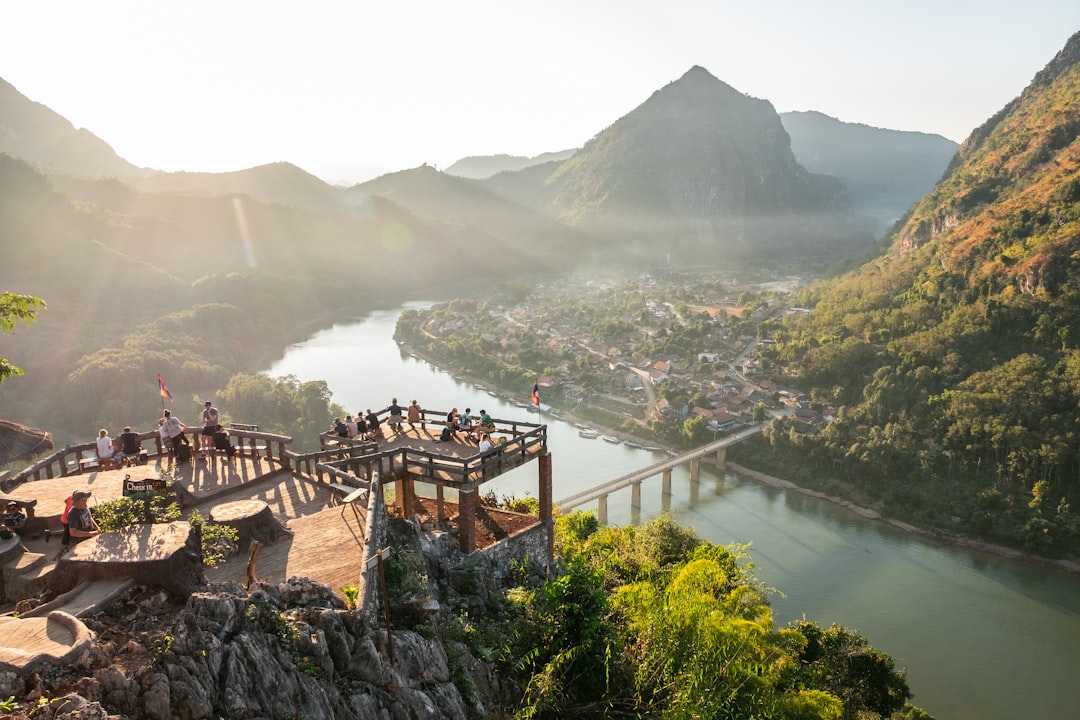 a group of people standing on top of a mountain,