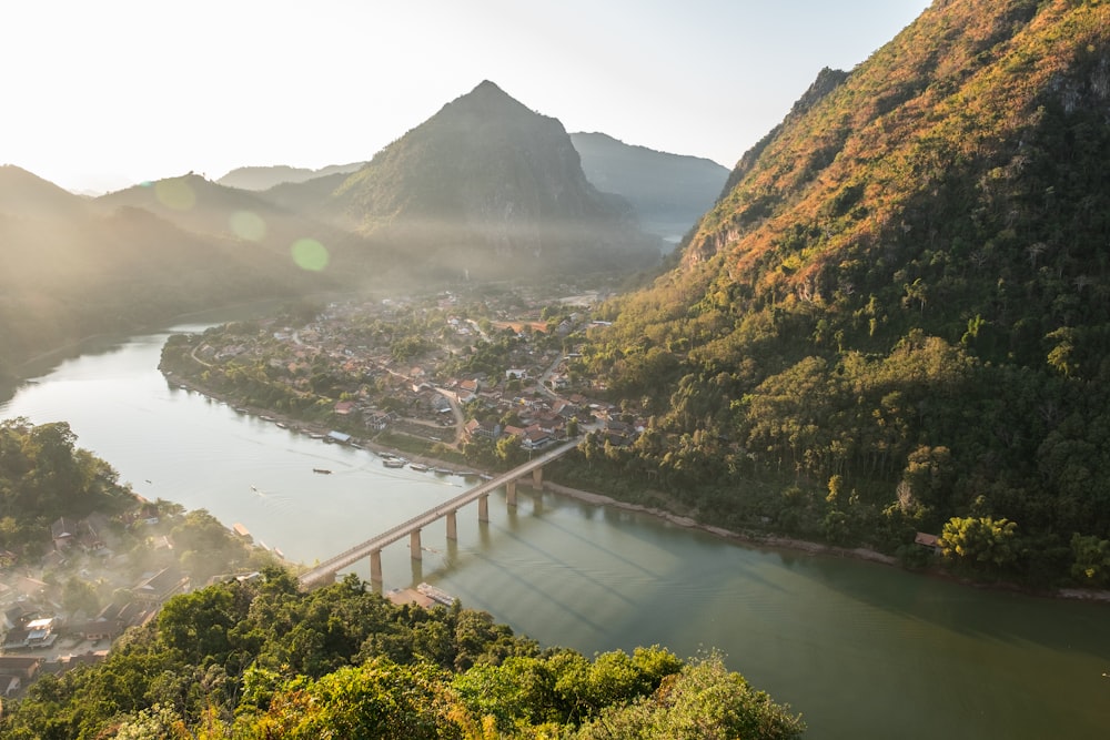 a bridge over a river surrounded by mountains