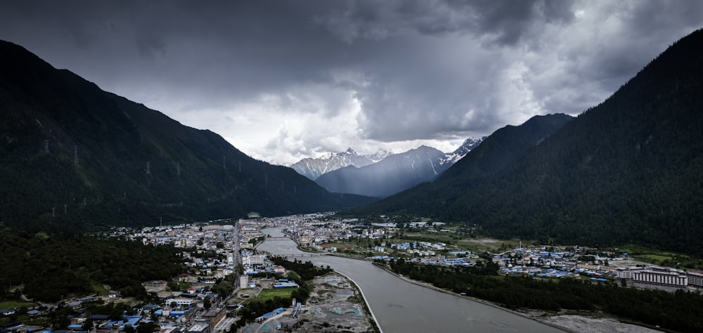 a river running through a valley surrounded by mountains