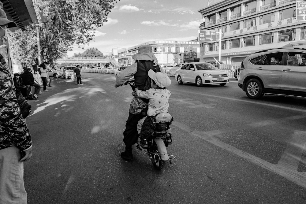 a black and white photo of a person on a scooter