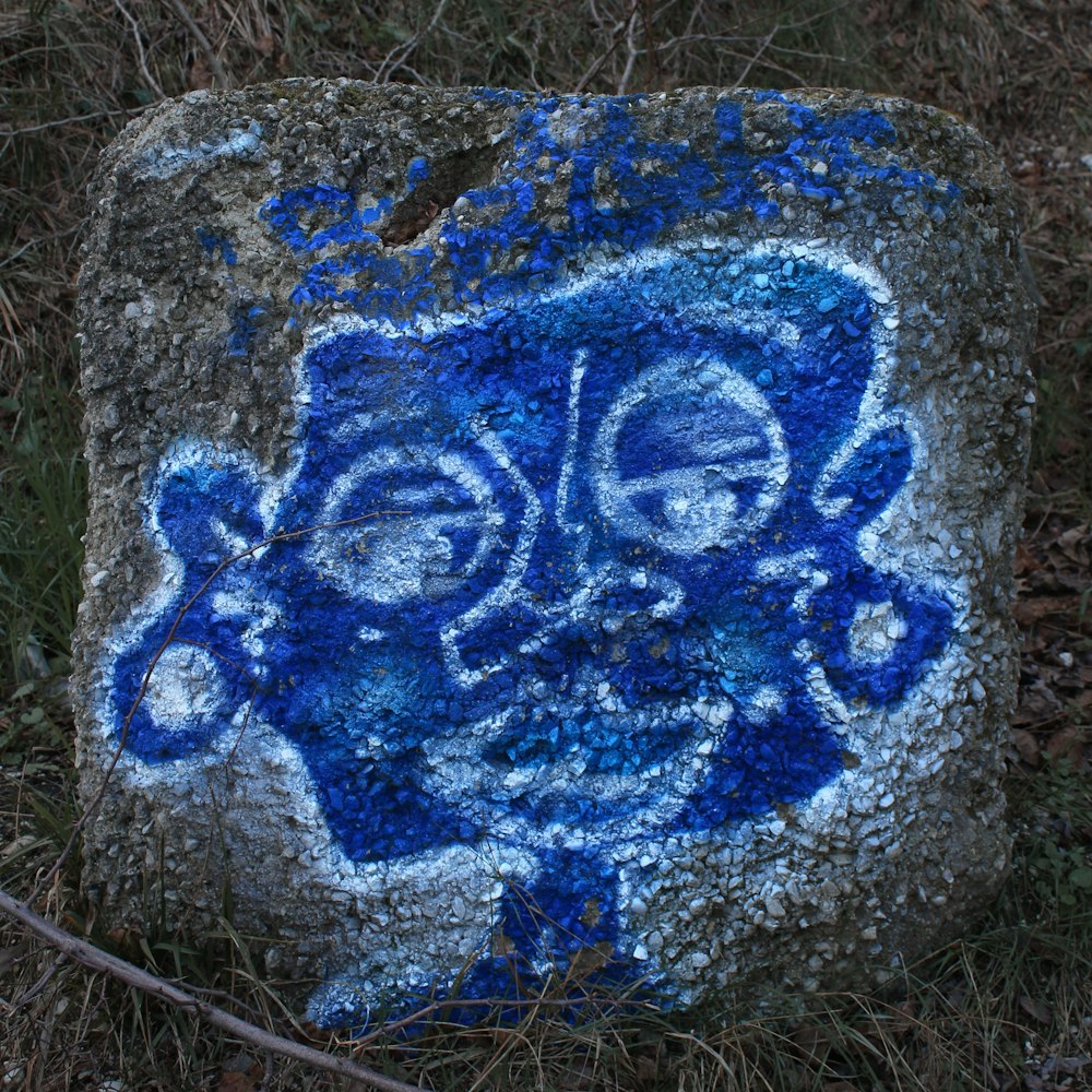 a rock with blue and white designs on it